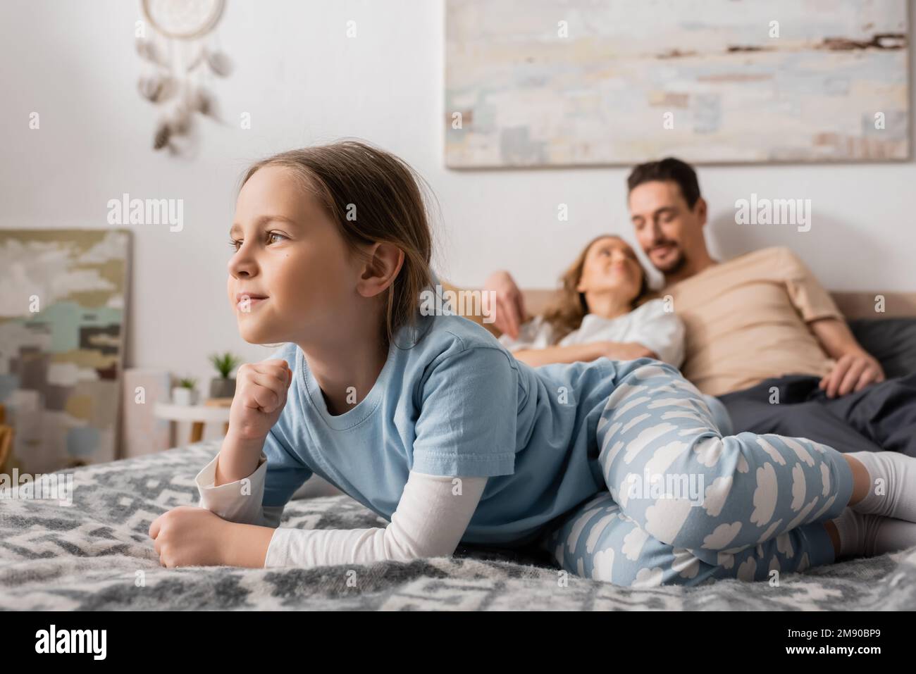 Cheerful girl lying on bed hi-res stock photography and images - Alamy