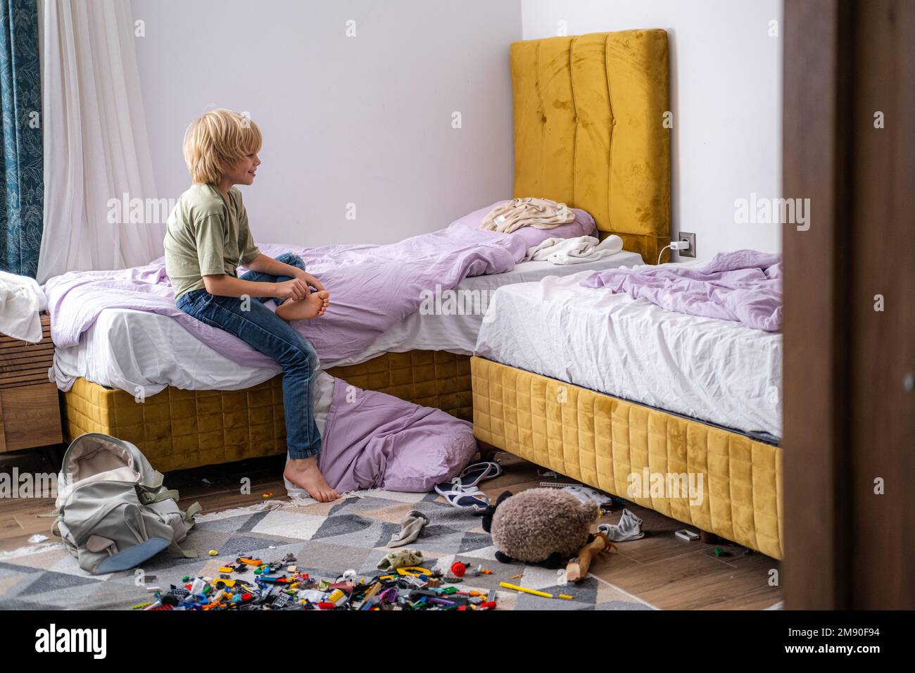boy having fun, jumping on bed in messy childrens room, kid playing ...