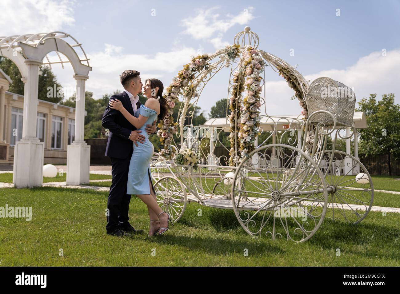 A happy romantic Caucasian couple at the decorated outdoor wedding area ...