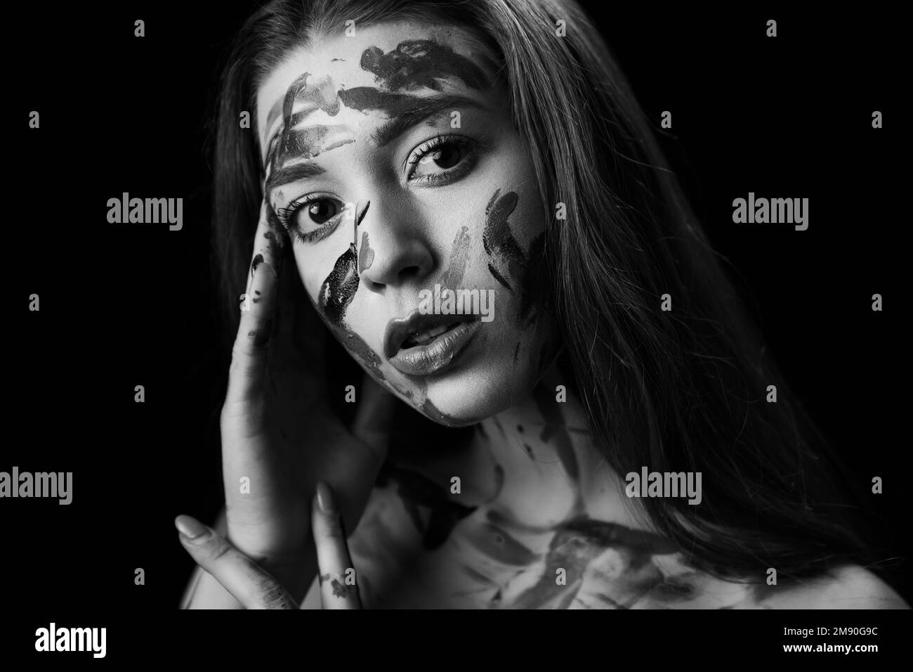A grayscale portrait of a young Caucasian woman with a gouache-painted ...