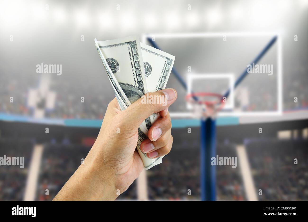 Close up of a man's hand crushing a wad of hundred dollar bills in concept of getting money with