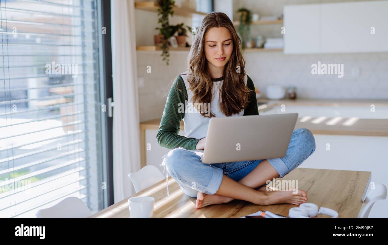 Young woman having homeoffice in her apartment. Stock Photo