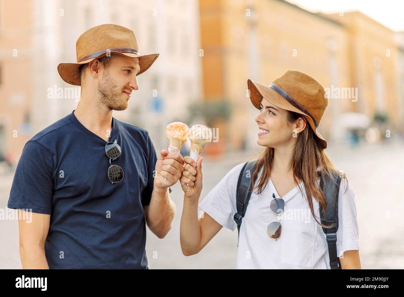 Happy couple eating ice cream in Rome, Italy. Beautiful bright ice cream with different flavors in the hands of a couple Stock Photo