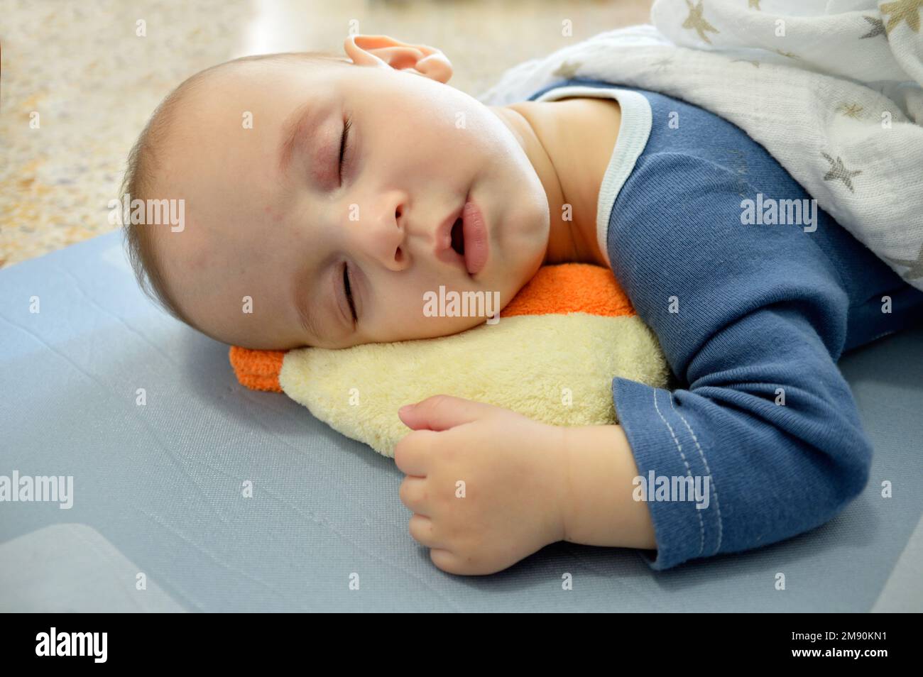 Cropped shot of an adorable baby boy taking a nap Stock Photo