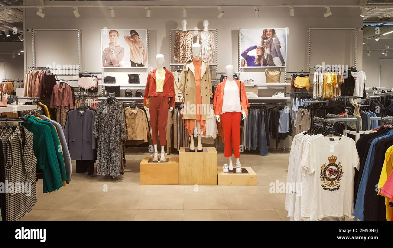 Three dressed mannequins standing in a store. Casual women's clothing store in the mall. Boutique mannequins in a fashion store. Shopping store Stock Photo