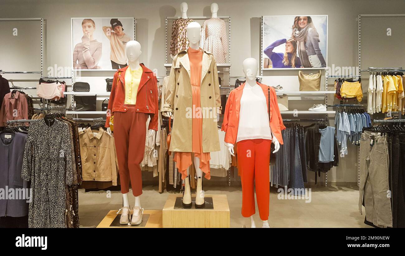 Three dressed mannequins standing in a store. Casual women's clothing store in the mall. Boutique mannequins in a fashion store. Shopping store Stock Photo