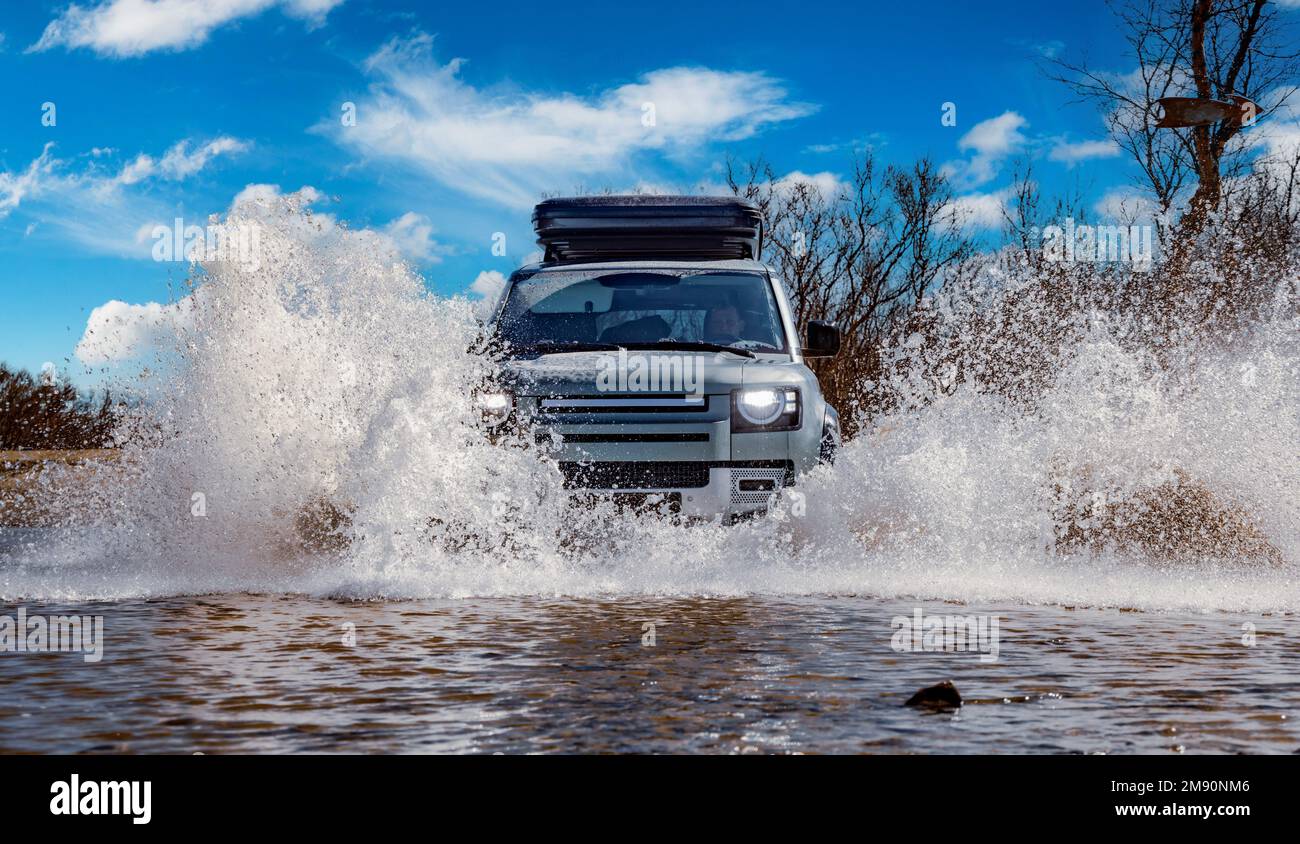 Off road tourist car rides off-road in the highlands. Expedition travel and vacation, adventures in remote areas. Stock Photo