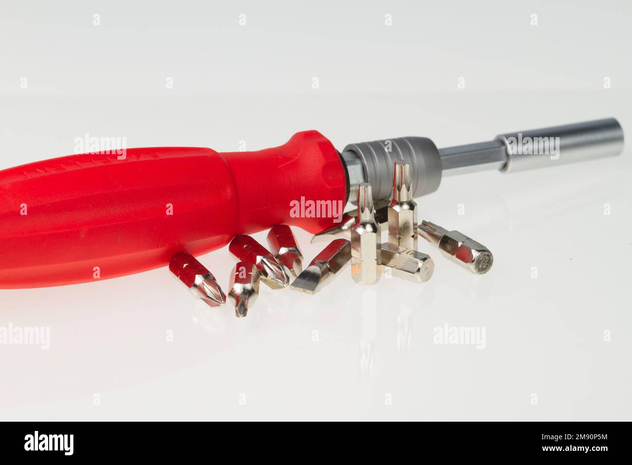 Screwdriver with various size sockets on white background Stock Photo