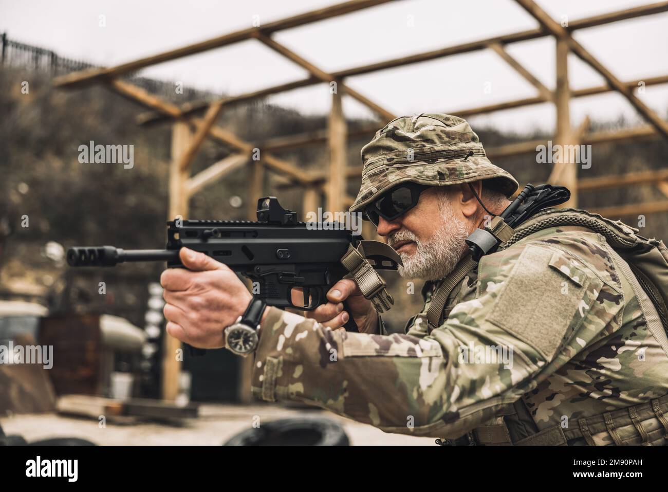 Mature soldier with a rifle in hands on a shooting range Stock Photo