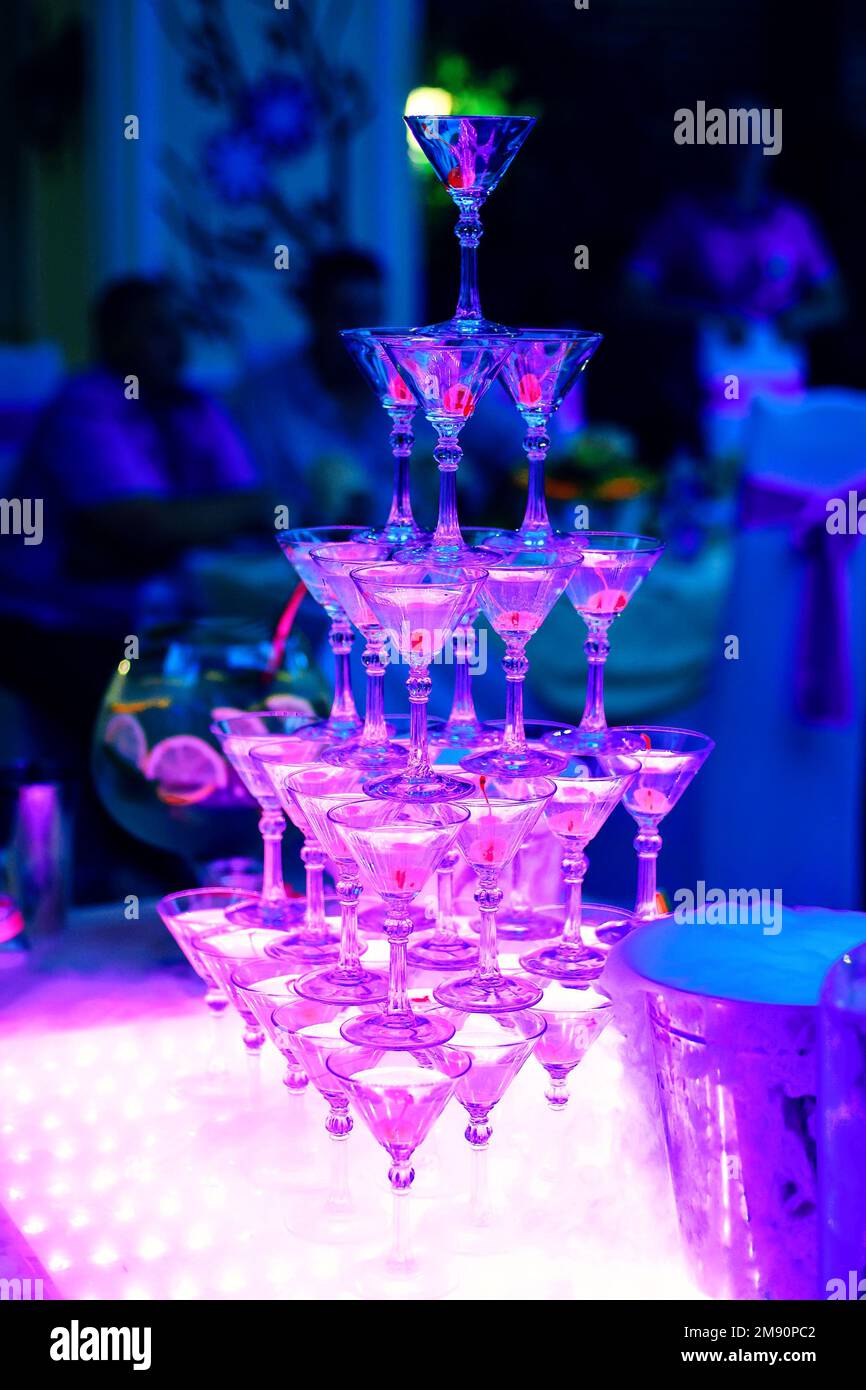 tower of Martini glasses in the restaurant with ultraviolet