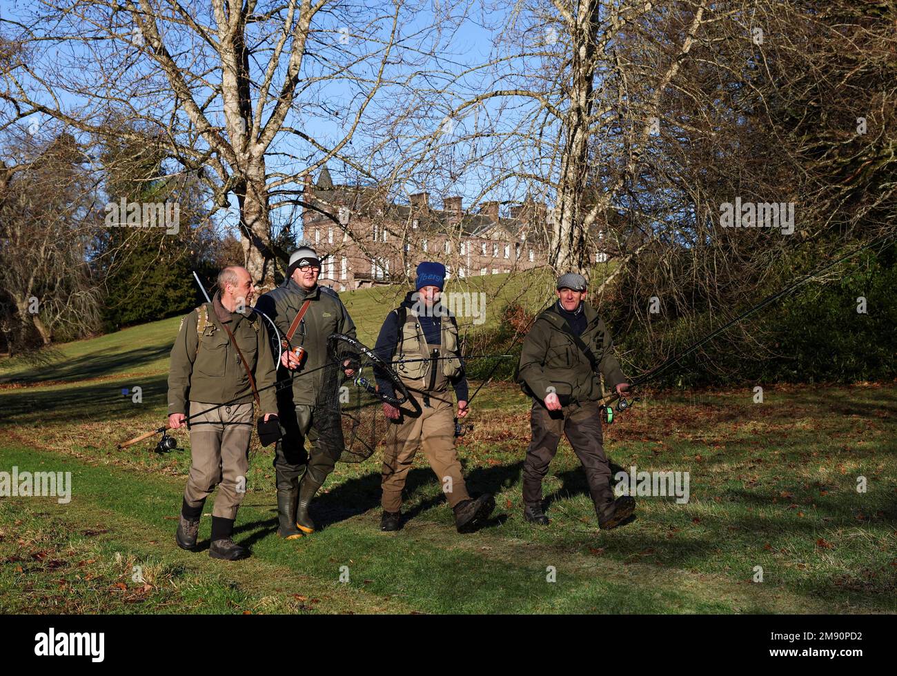 Anglers walk along the bank on the opening day of the salmon fishing season on the river Tay at Meikleour fisheries, Scotland, Britain, January 16, 2023. REUTERS/Russell Cheyne Stock Photo