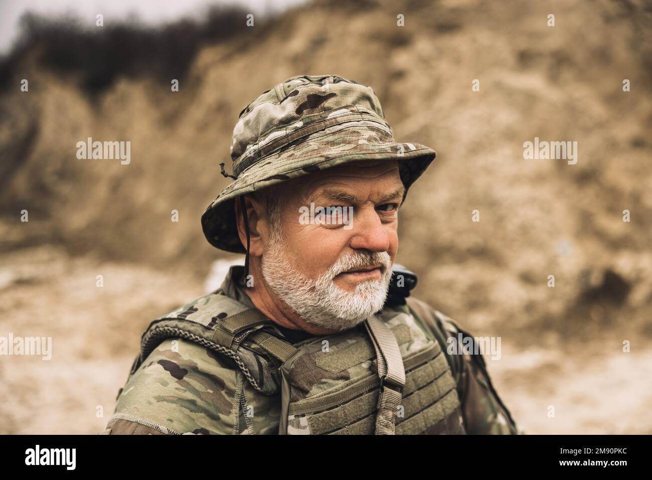 Mature bearded soldier on a shooting range Stock Photo