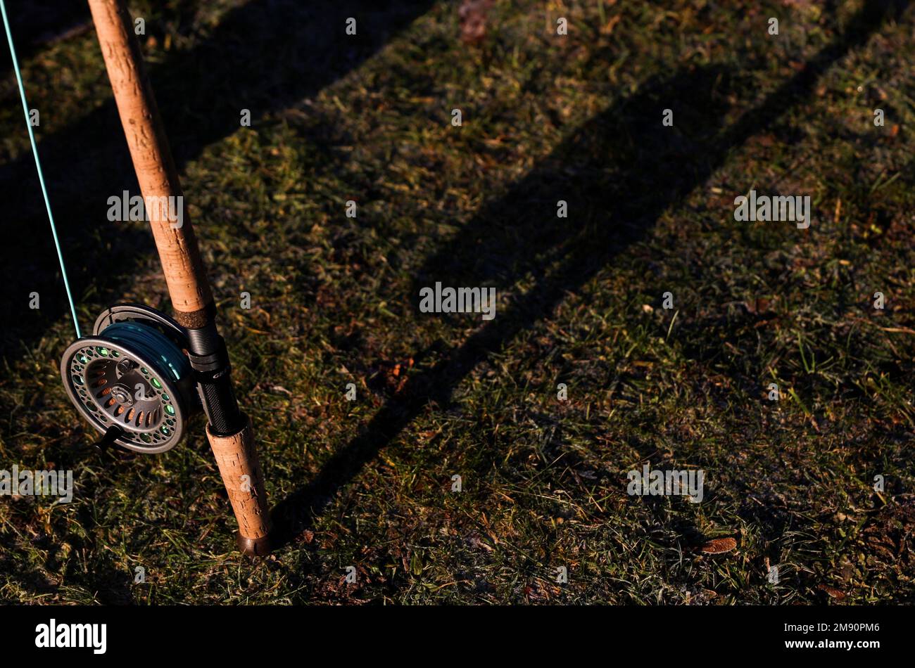 A rod and reel cast a shadow on the the bank on the opening day of the salmon fishing season on the river Tay at Meikleour fisheries, Scotland, Britain, January 16, 2023. REUTERS/Russell Cheyne Stock Photo