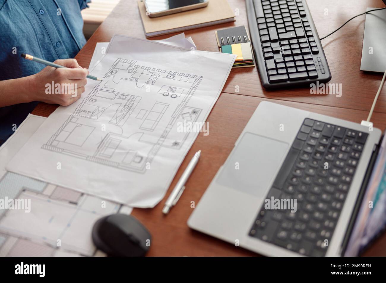 Woman engineer construction is developing construction project documentation sitting at home office Stock Photo