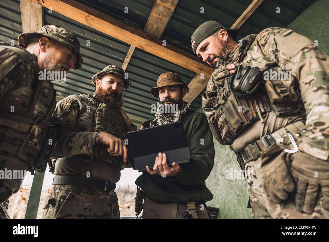 Group of soldiers discussing something before combat Stock Photo