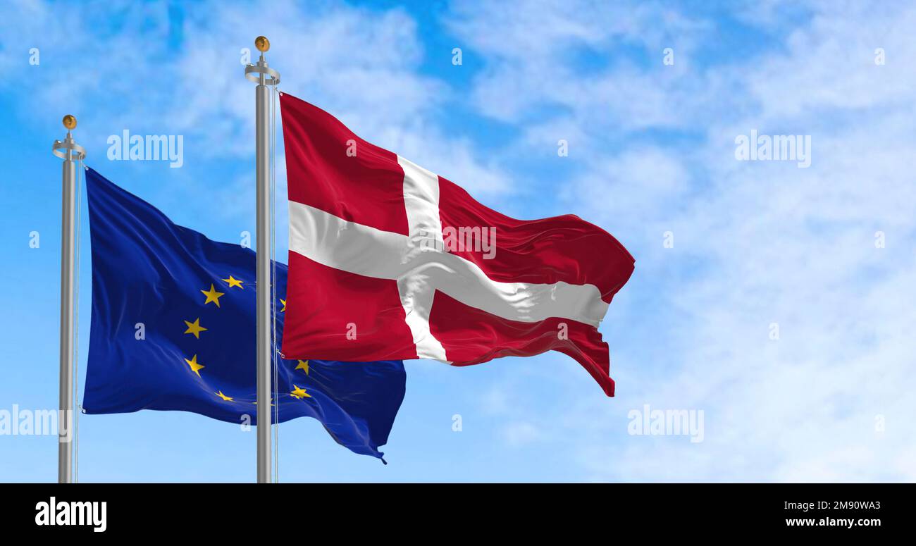 The flags of Denmark and the European Union waving together on a clear day. Denmark became a member of the European Union on January 1, 1973. Realisti Stock Photo