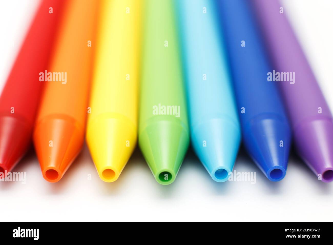 Multicolored in rainbow colors gel pens isolated on a white background, close-up. Copy space. Stock Photo