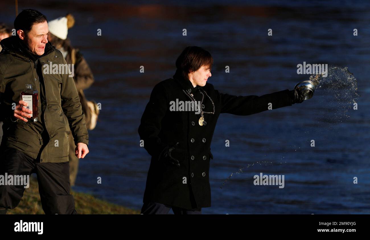 Xander McDade blesses the river with whisky on the opening day of the salmon fishing season on the river Tay at Meikleour fisheries, Scotland, Britain, January 16, 2023. REUTERS/Russell Cheyne Stock Photo