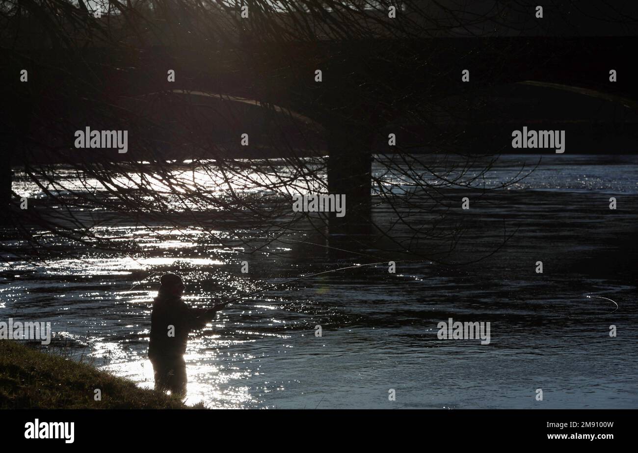An angler casts a line on the opening day of the salmon fishing season on the river Tay at Meikleour fisheries, Scotland, Britain, January 16, 2023. REUTERS/Russell Cheyne Stock Photo