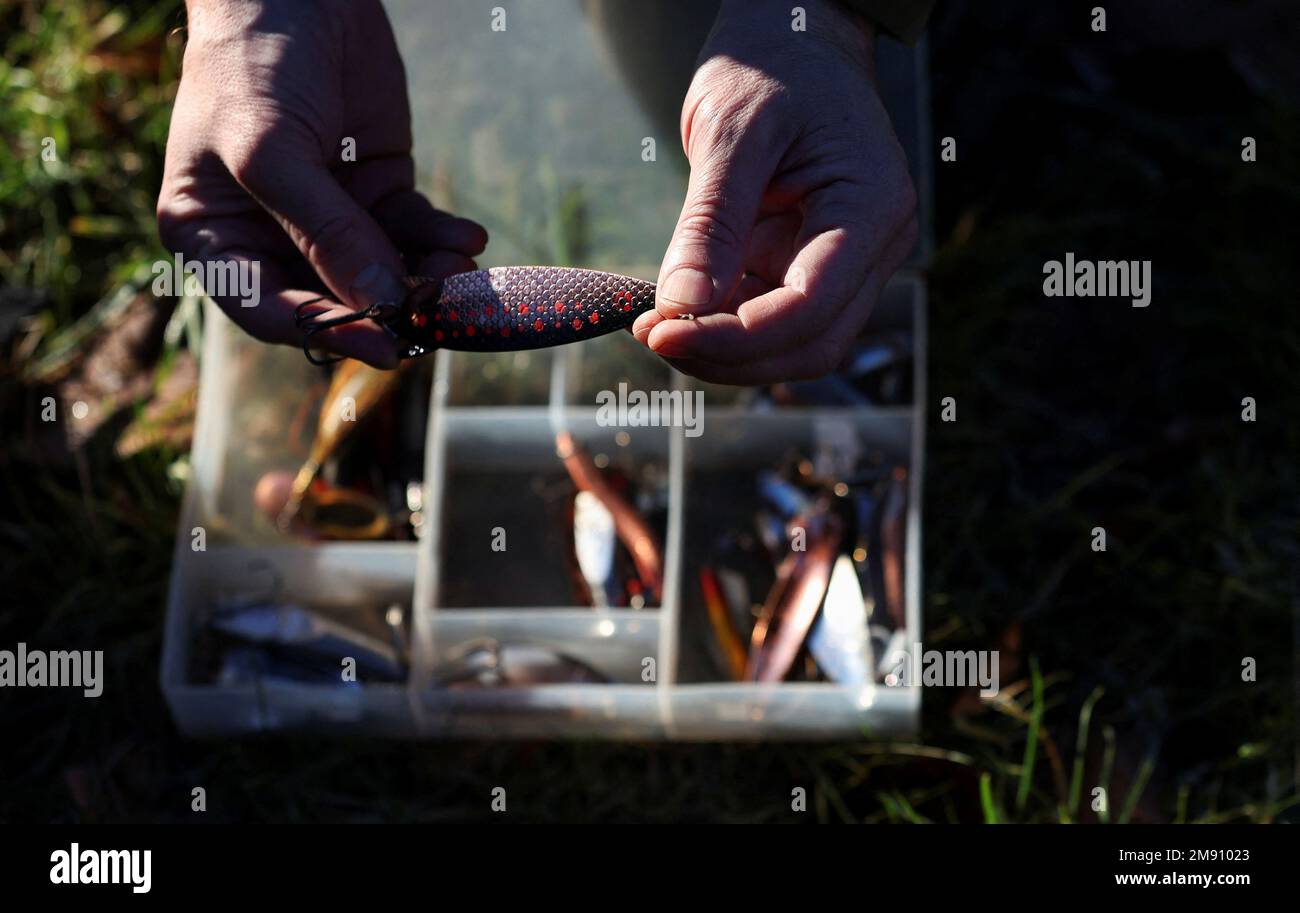 An angler choses their lure on the opening day of the salmon fishing season on the river Tay at Meikleour fisheries, Scotland, Britain, January 16, 2023. REUTERS/Russell Cheyne Stock Photo