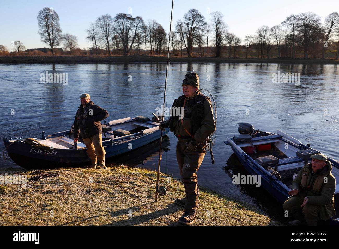 An angler waits on the bank on the opening day of the salmon fishing season on the river Tay at Meikleour fisheries, Scotland, Britain, January 16, 2023. REUTERS/Russell Cheyne Stock Photo
