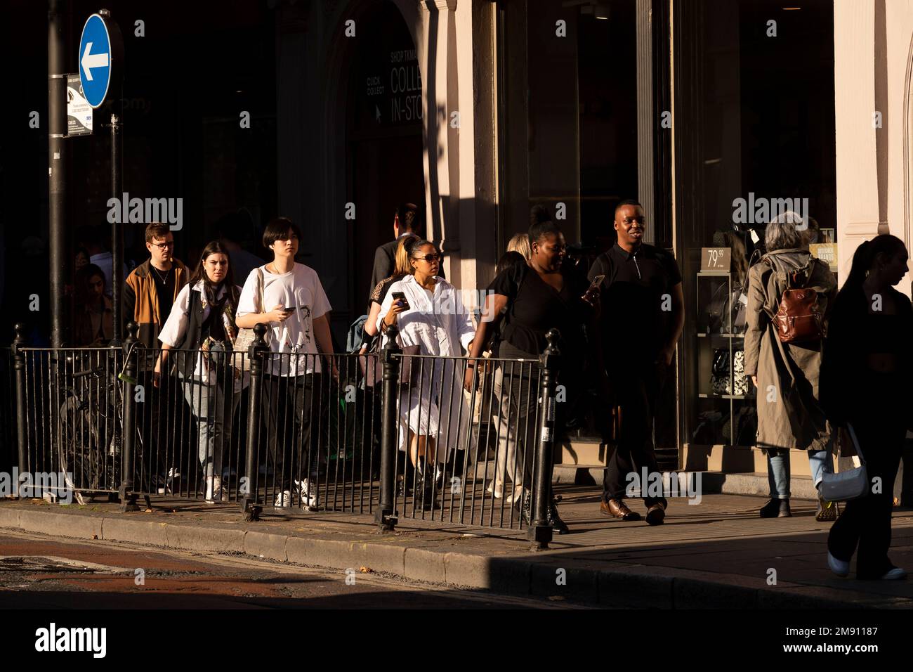 Multiethic street scene of pedestrians walking along, Charing Cross