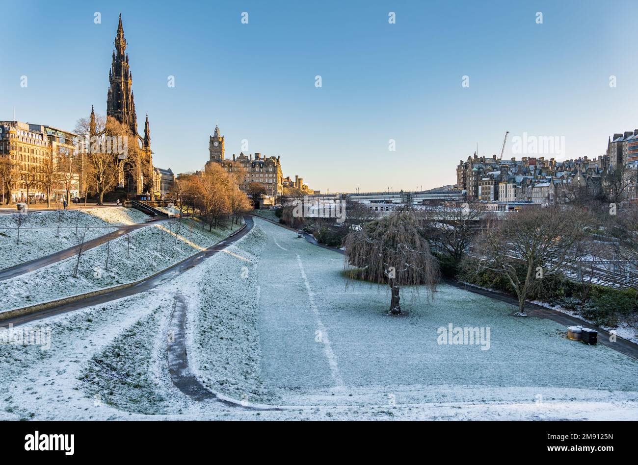 Princes Street Gardens, Edinburgh, Scotland, UK, 16th January 2023. UK Weather: A hard frost and sunny morning seen in Princes Street Gardens with a view of the city centre and the Scott monument and Balmoral clock tower. Credit: Sally Anderson/Alamy Live News Stock Photo