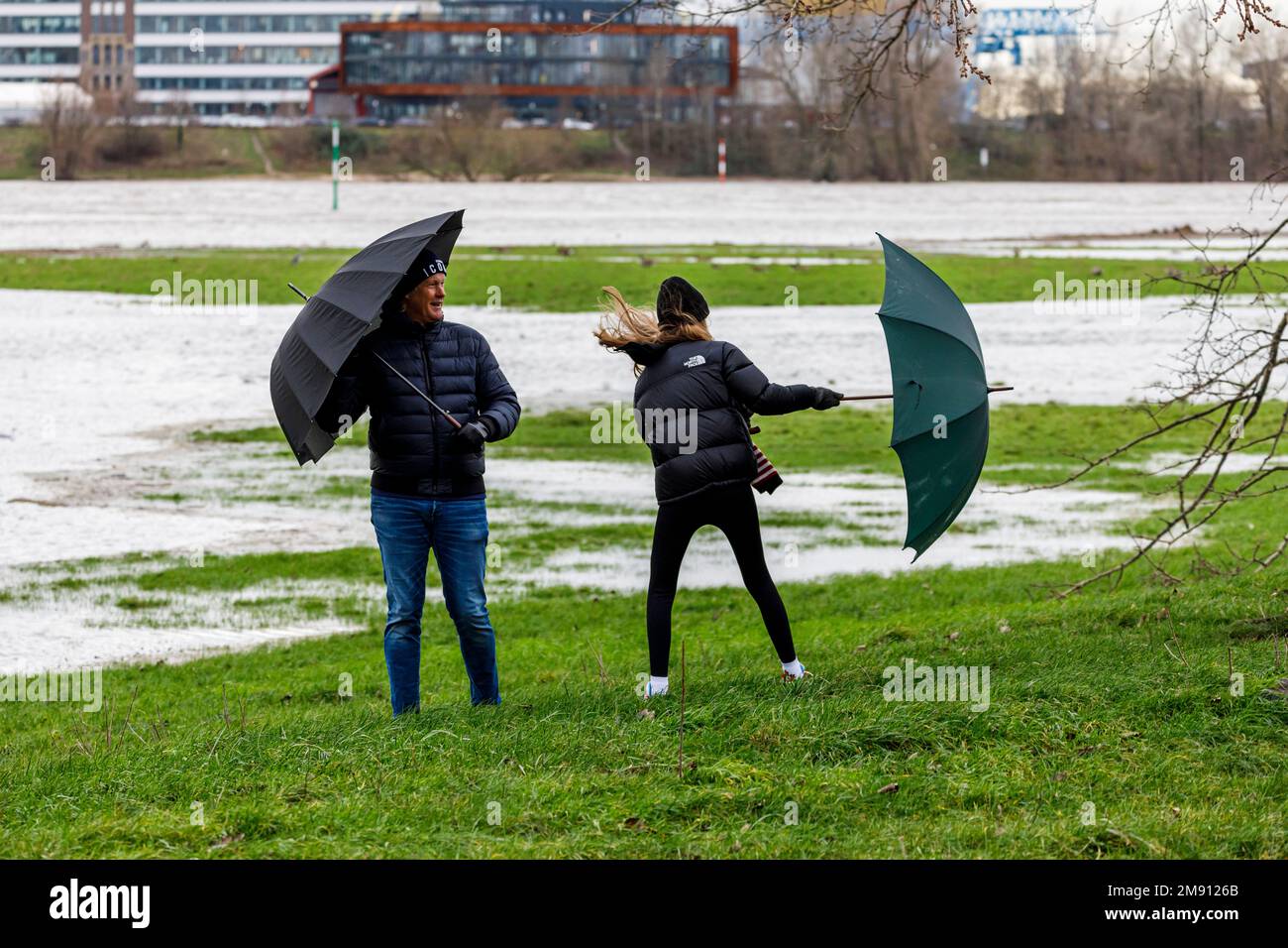 Rising water level on the Rhine in Düsseldorf, plus rain and stormy weather, father and daughter on the banks of the Rhine Stock Photo