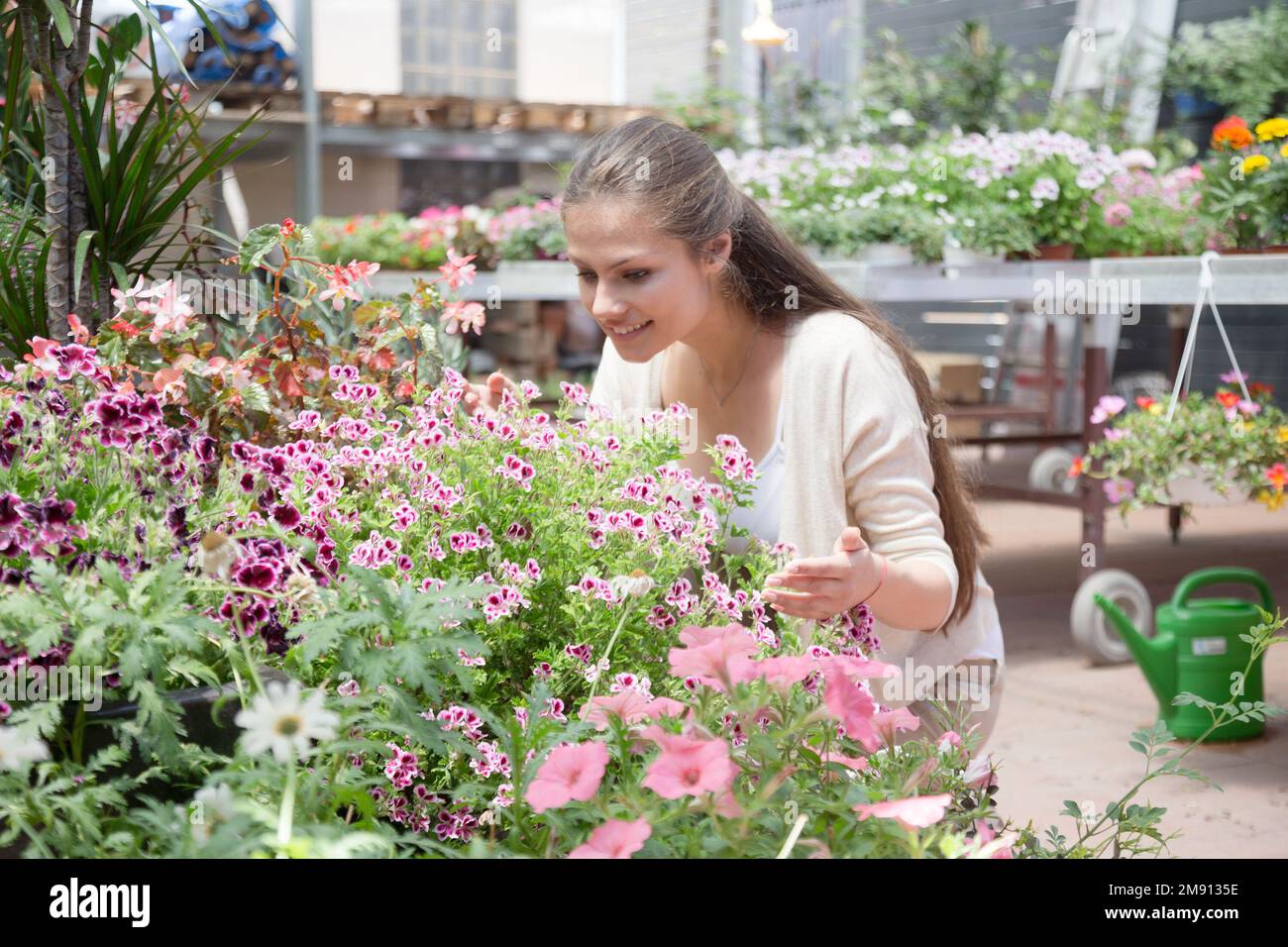 young lovely saleswoman in flower shop Stock Photo