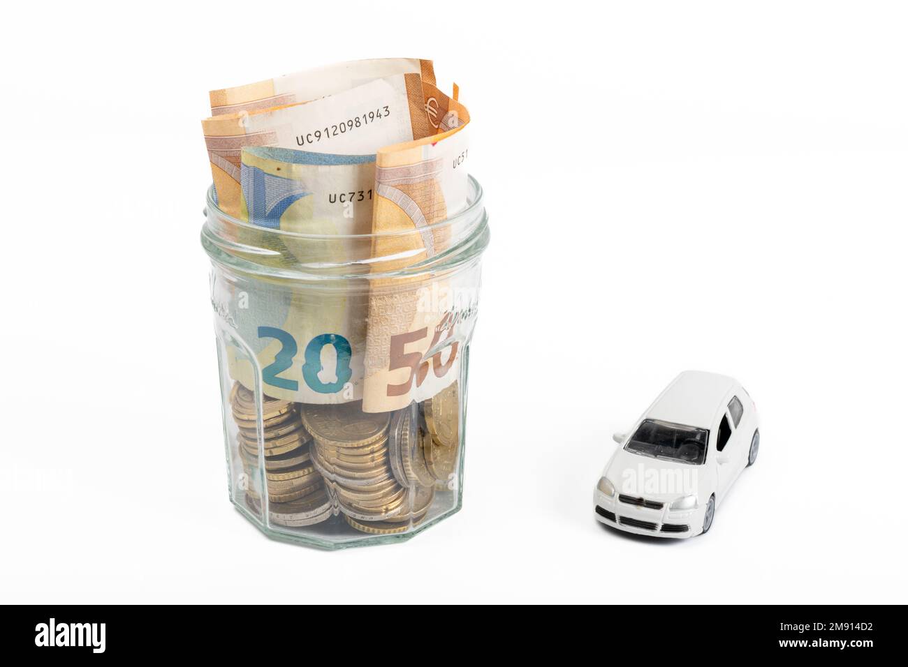 Miniature car model and financial statement with coins finance and car