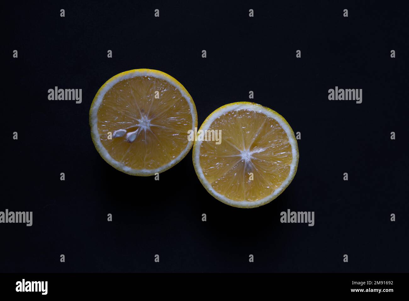 sweet lime cut in half on black background Stock Photo - Alamy