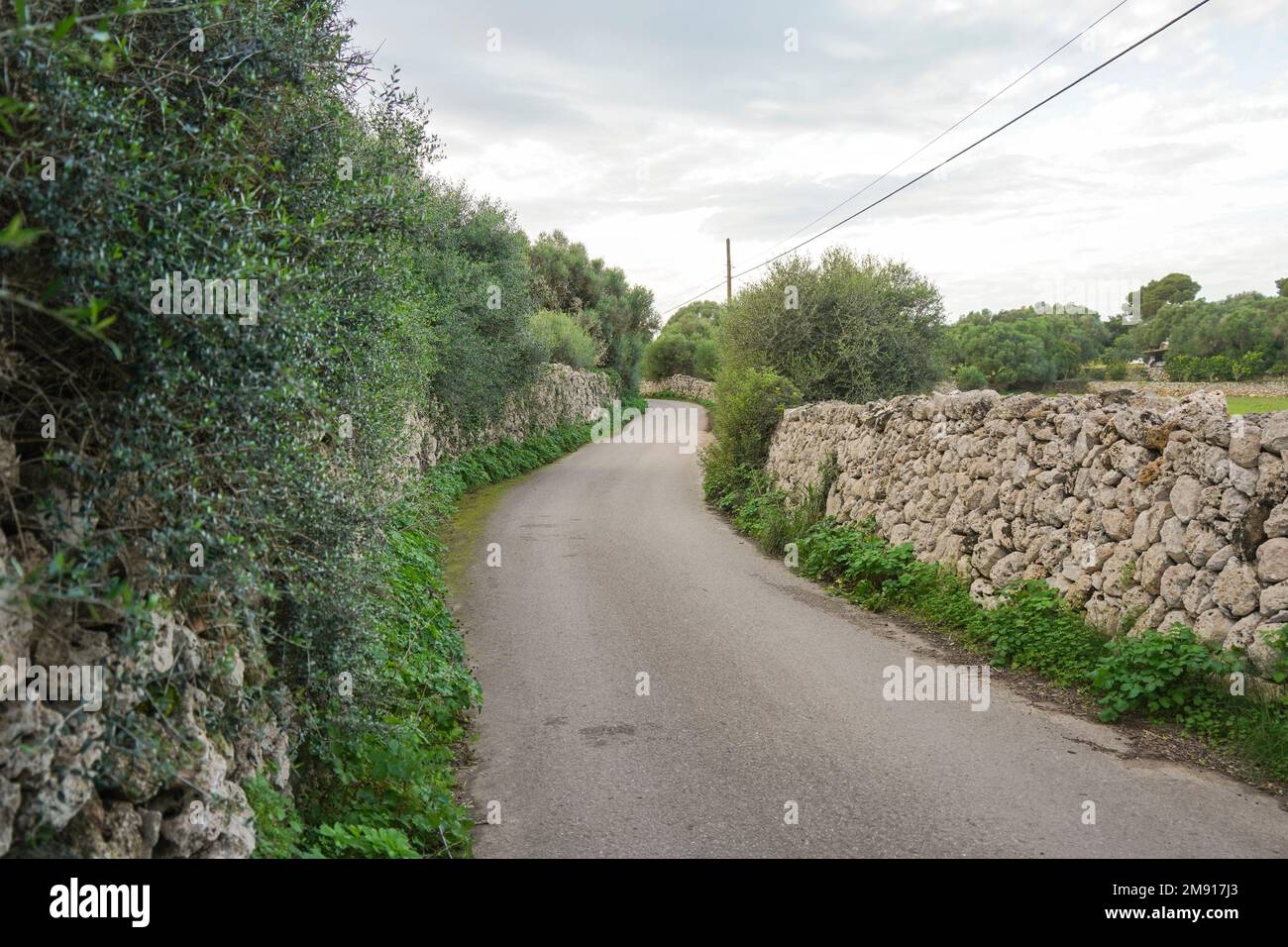 Countryside road with typical dry stone walls, Menorca, Balearic islands, Spain. Stock Photo