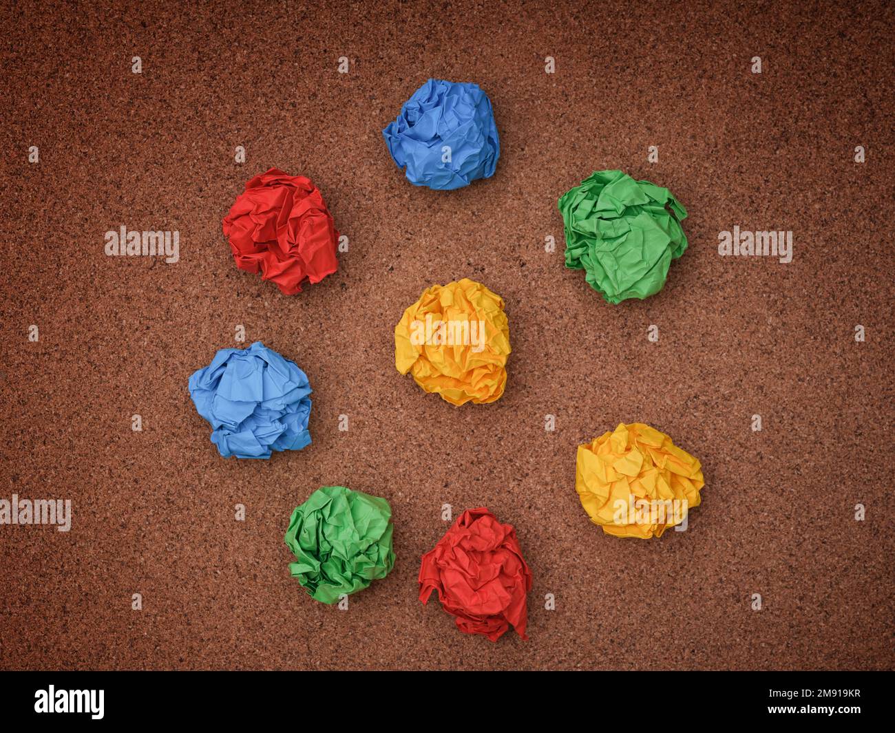 Colorful crumpled paper balls on a cork board. Idea Concept. Stock Photo