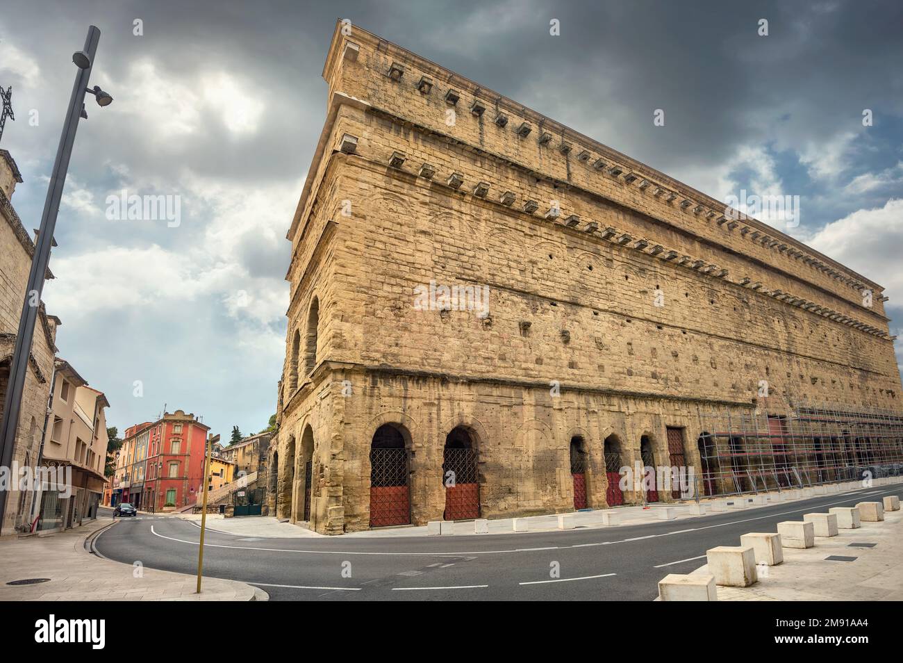 Street part facade of ancient Roman Theatre in historic town Orange. France, South France Stock Photo