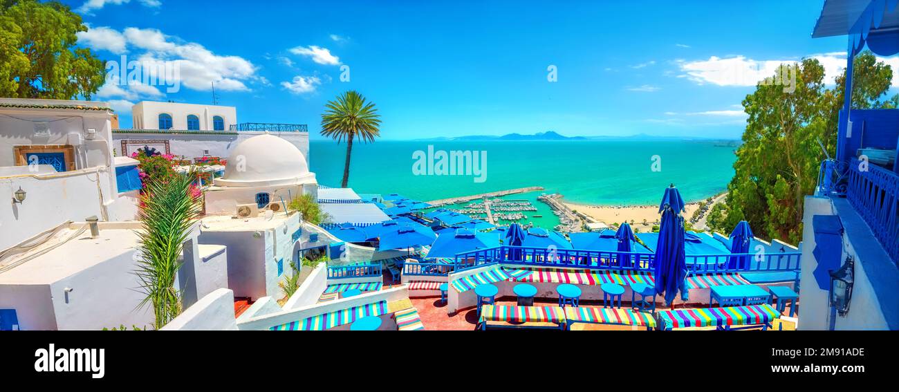 Panoramic view of open cafe and seafront with beach in Sidi Bou Said (blue white town). Tunisia, North Africa Stock Photo
