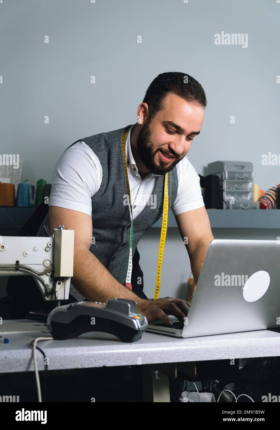Tailor man working at his atelier Stock Photo