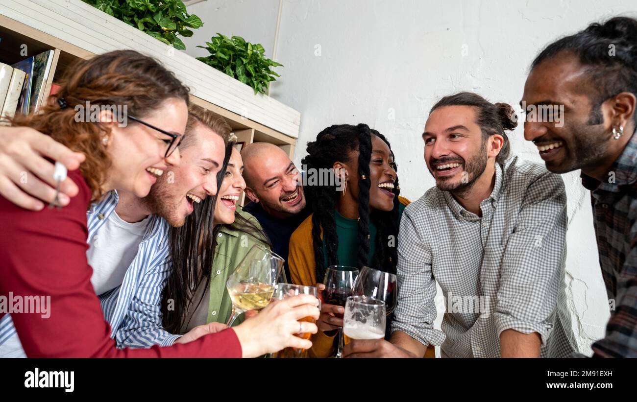 Happy friends drinking beers and wine, celebrating event at restaurant