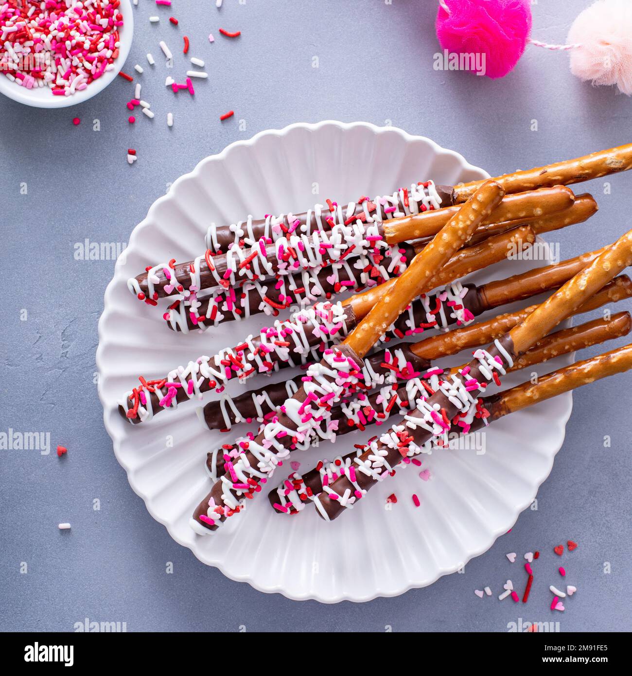 Valentines day treat, chocolate covered pretzel rods with sprinkles