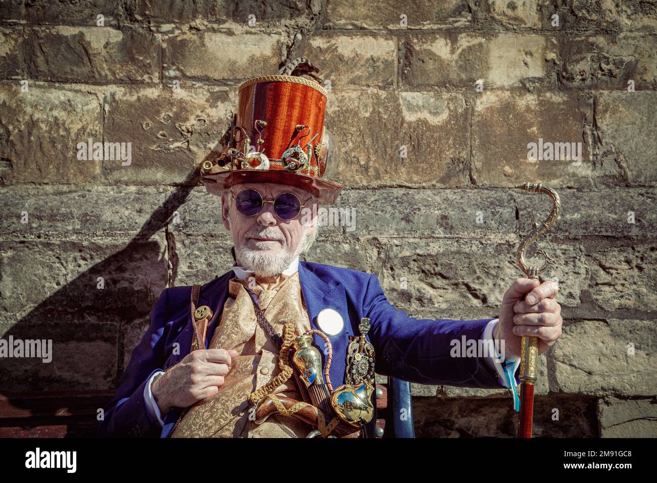 A stylish male wearing retro futuristic steampunk clothing and a wooden top hat. Stock Photo