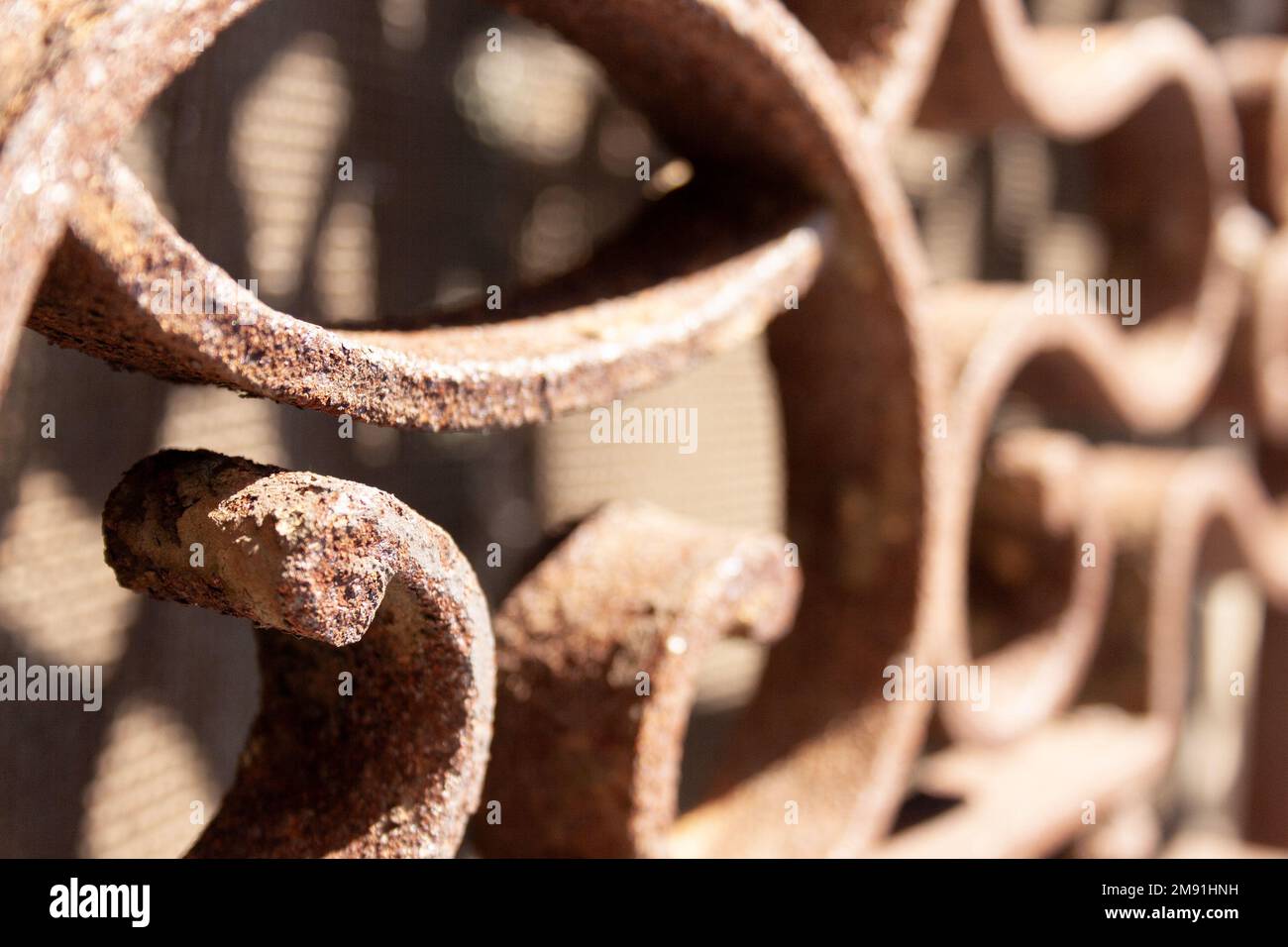 selective focus of a rusted iron window with circular and spiral shapes Stock Photo