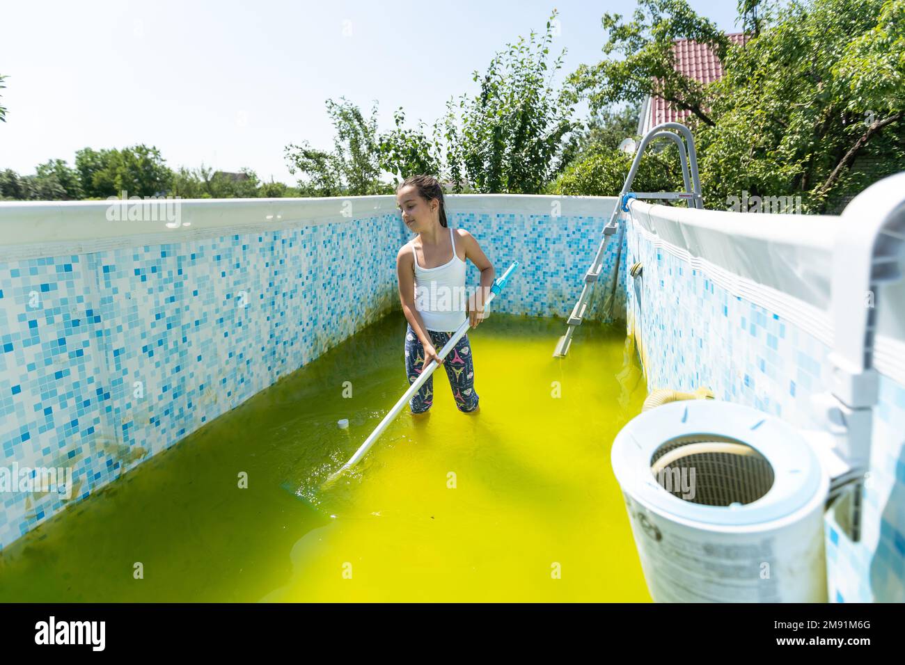 a little girl cleans a very dirty pool Stock Photo Alamy