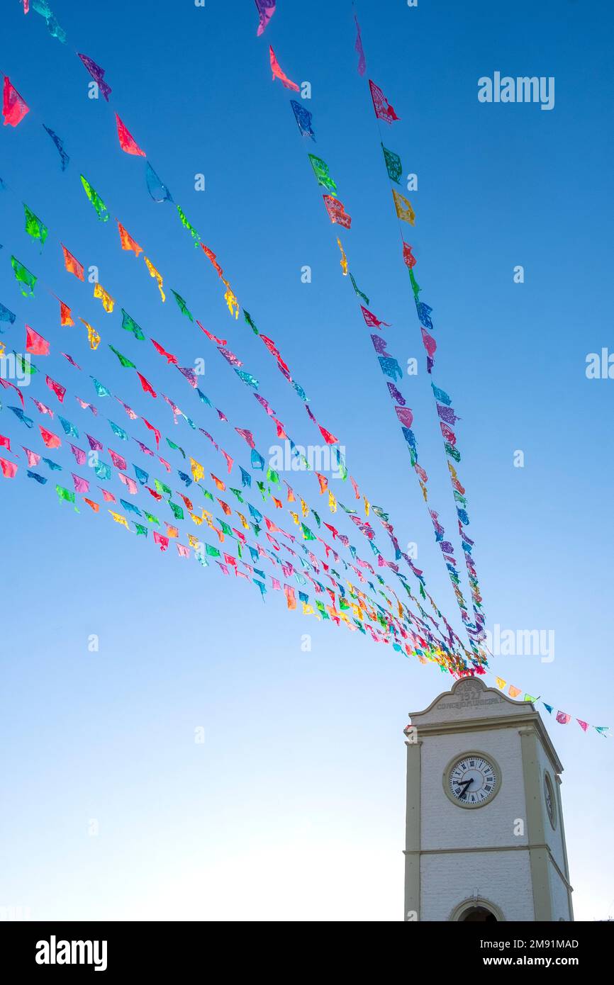 Colorful streamers in the blue sky, Palacio Municipal, San José del Cabo, Baja California, Mexico Stock Photo