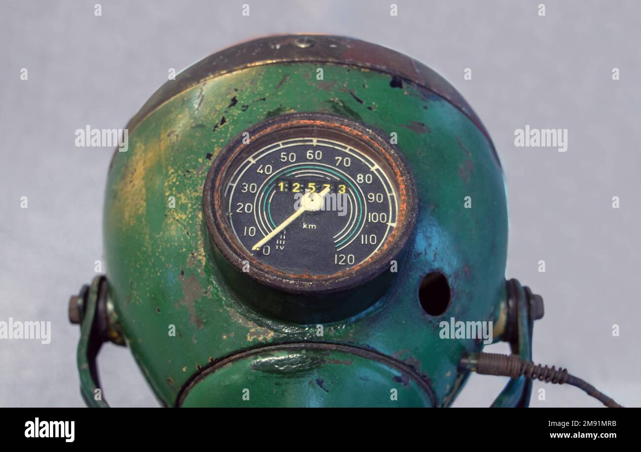The old motorcycle headlight with speedometer, closeup view Stock