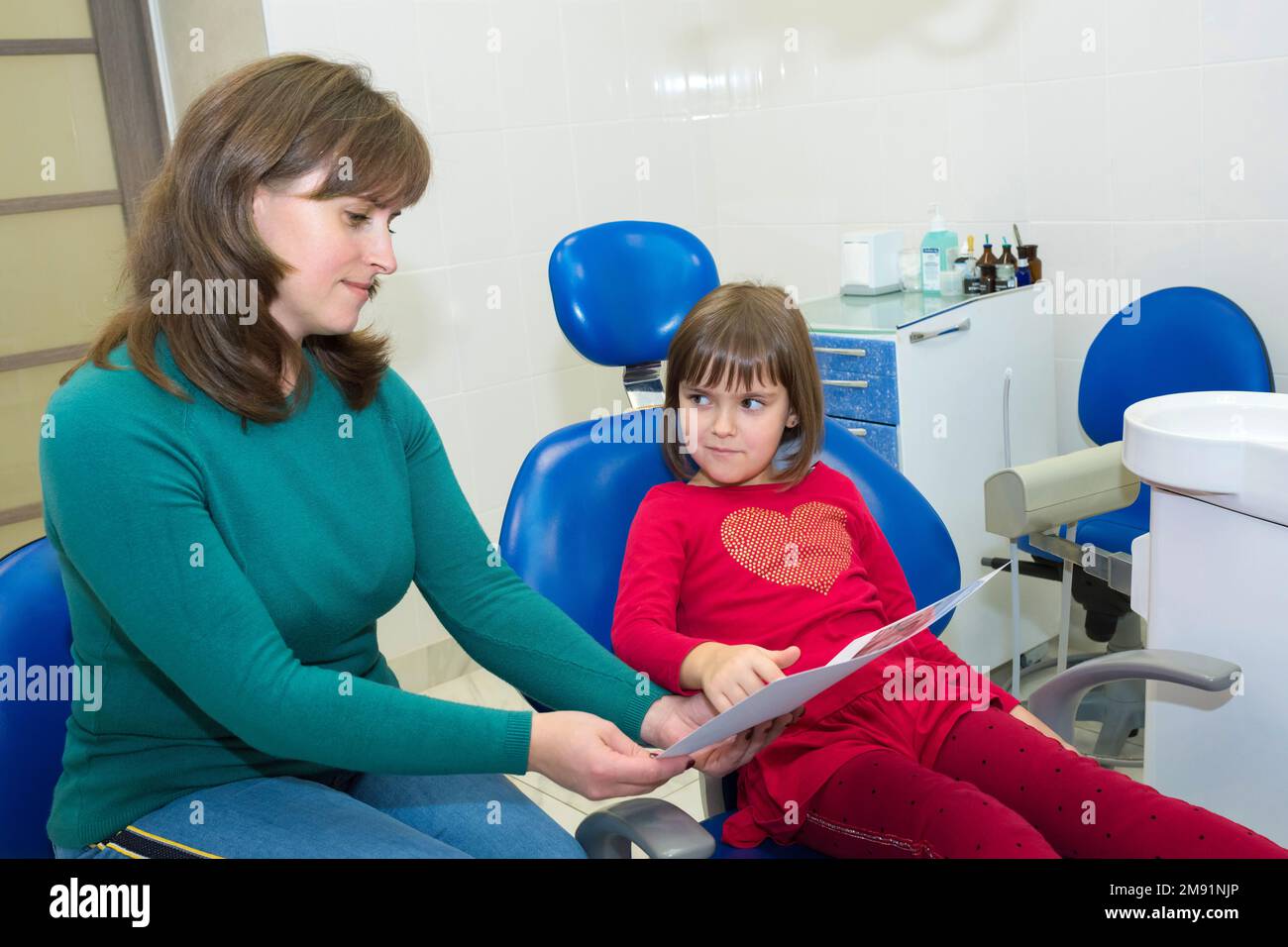 A mother is showing her daughter dental Xrays Stock Photo Alamy