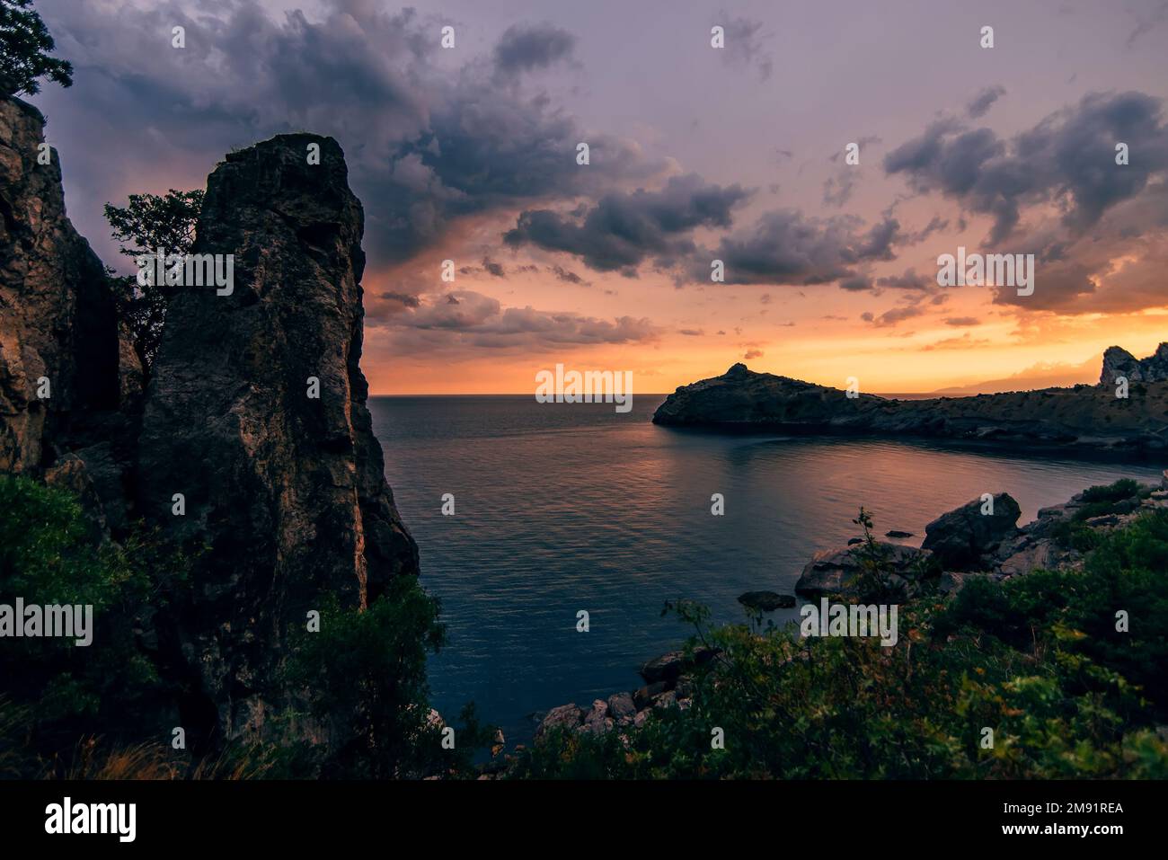 mountains and the sea on the background of beautiful sunset sky with ...
