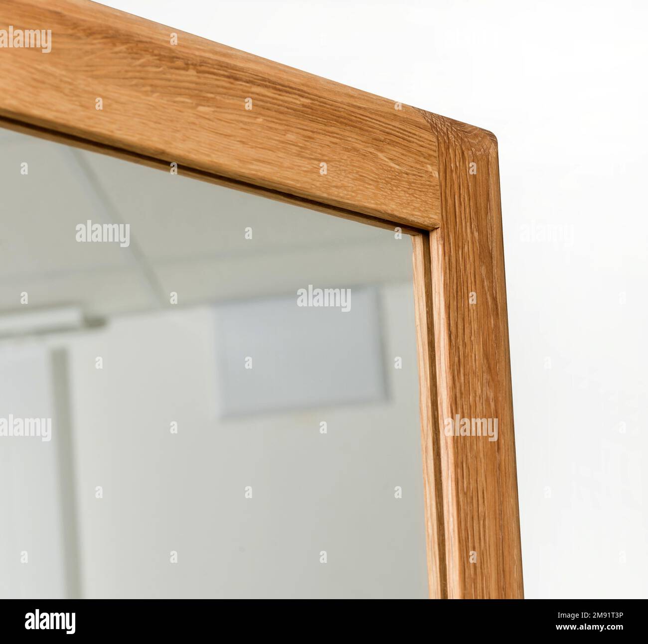 Wooden mirror frame corner isolated over white background, wooden eco furniture elements. Solid wood furniture leg Stock Photo