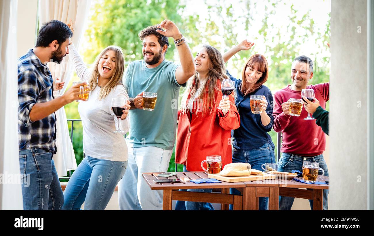 Young people having fun eating at home balcony dinner party Happy