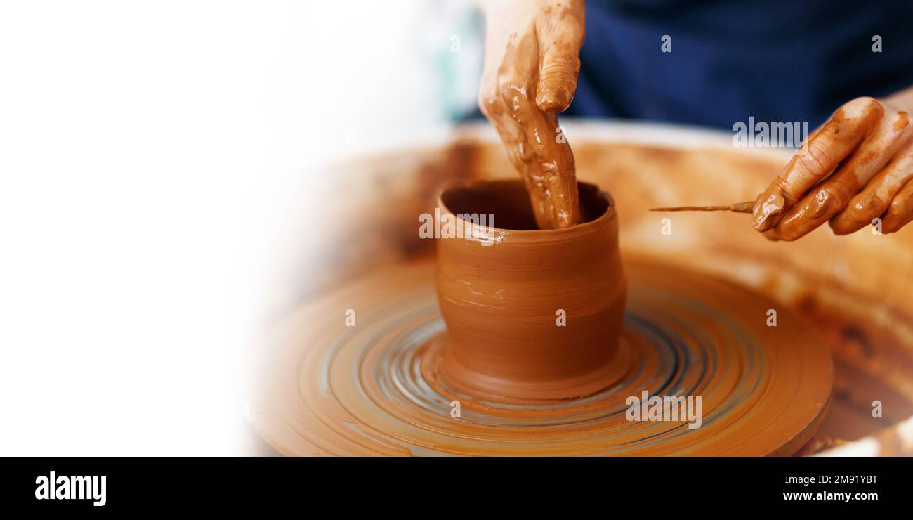 Cropped Image of hands working with Pottery Wheel, close up of shaping clay edges, banner, copy space. Stock Photo