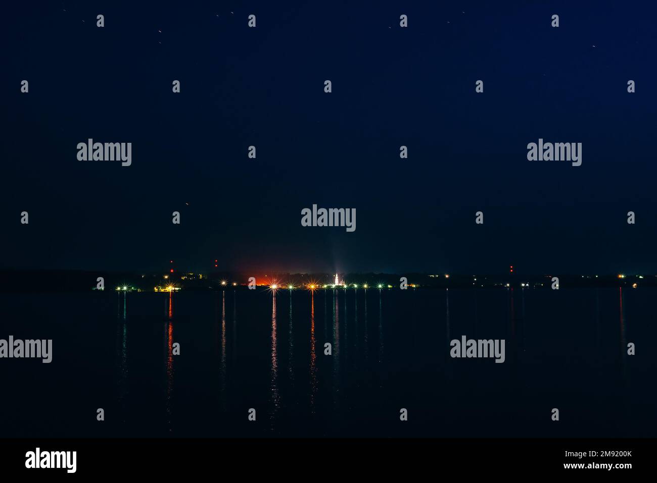 night city night on the river with reflection in the water under the ...
