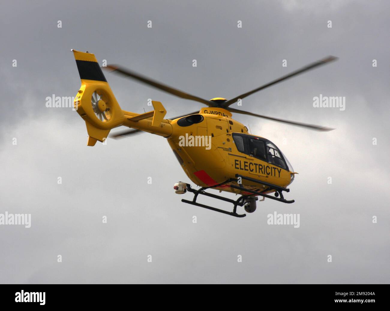 A Eurocopter EC 135P1 helicopter Western Power Distribution leaves Fenland Airfield Stock Photo